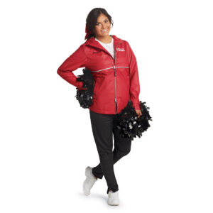 model posing in a red jacket and black Augusta tapered leg warmup pants