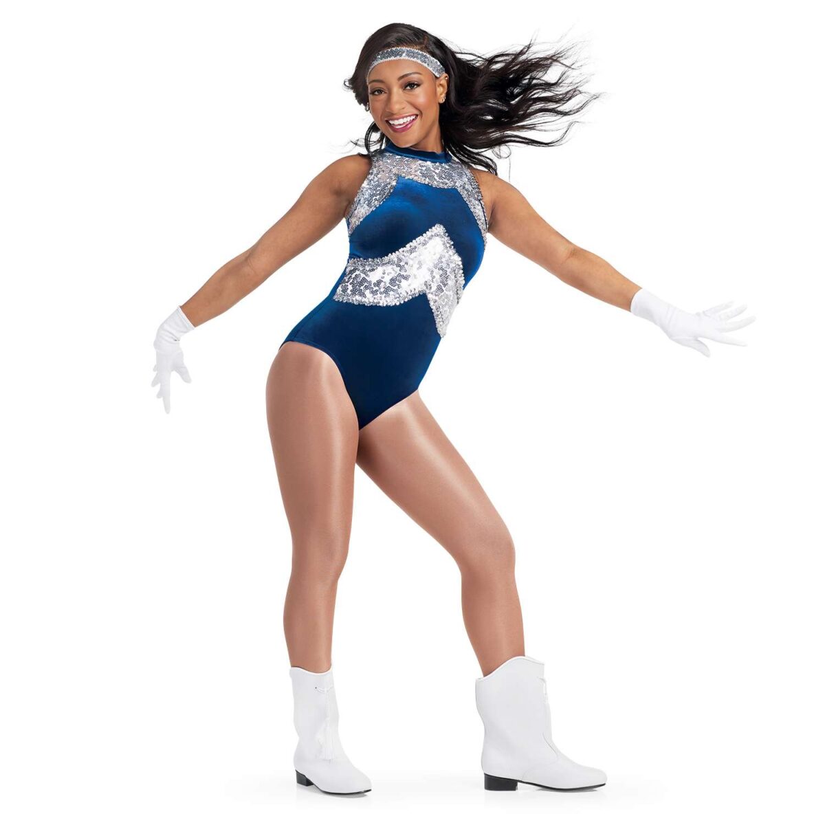 front three-quarter view of dancer in blue sequin leotard with silver accents, white gloves and boots.