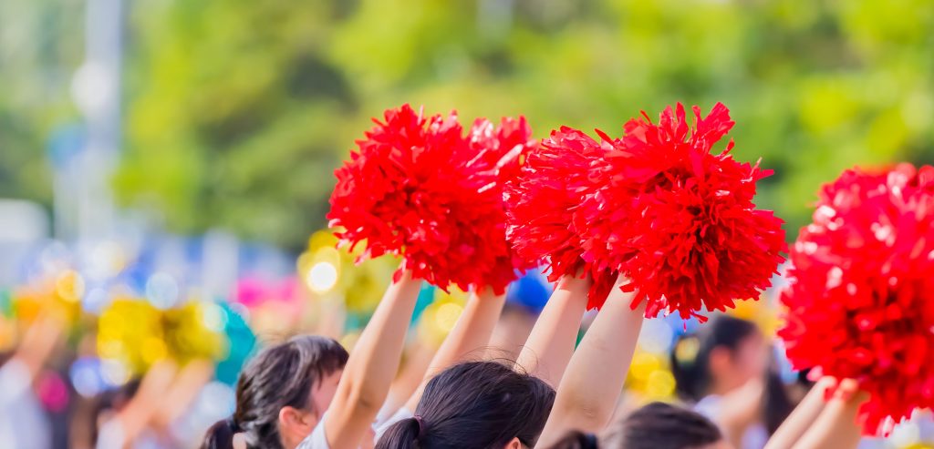 Cheerleaders shaking poms during a parade