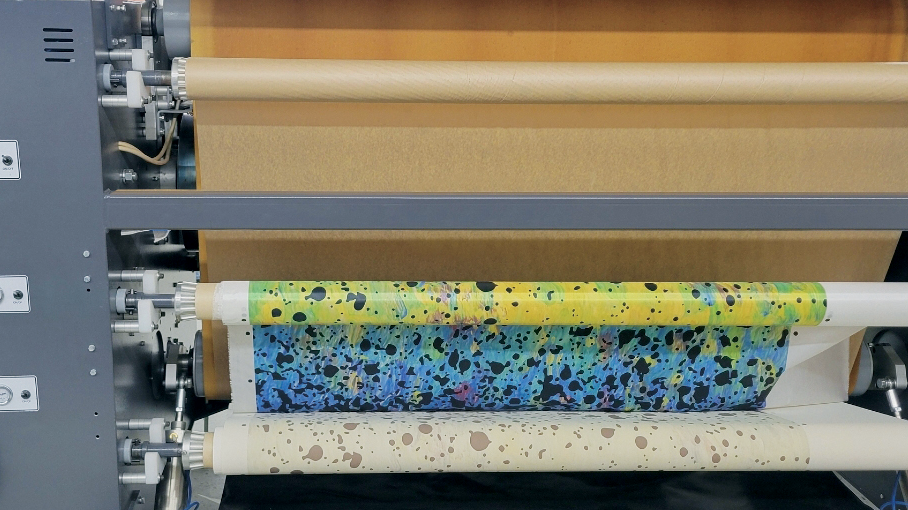 heat press machine rolling fabric onto a roll